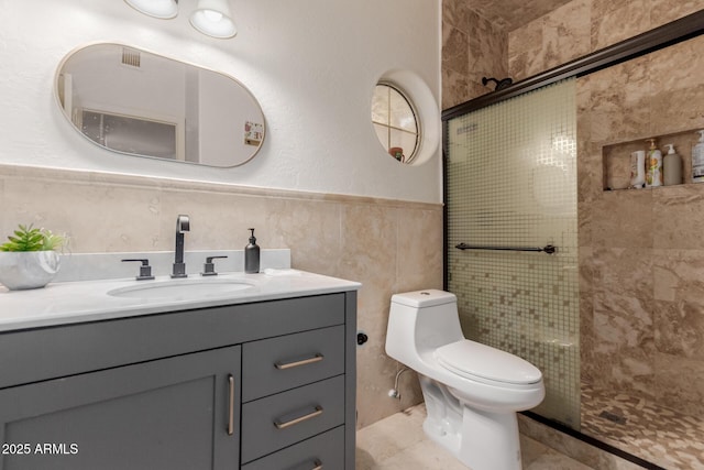5237 N 106th Ave, Glendale, AZ 85307 - full bathroom featuring vanity, a tile shower, tile walls, a wainscoted wall, and tile patterned flooring