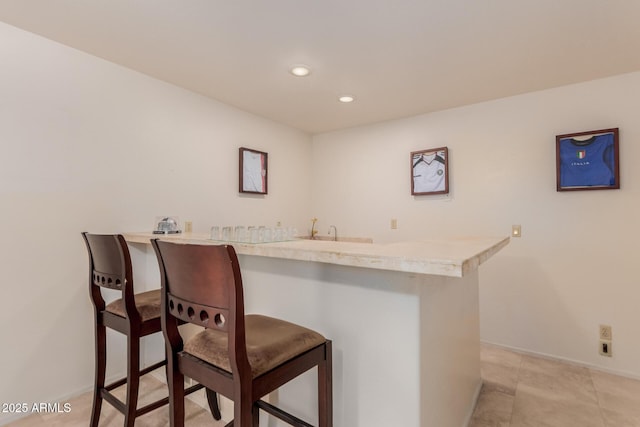 5237 N 106th Ave, Glendale, AZ 85307 - bar with baseboards and recessed lighting