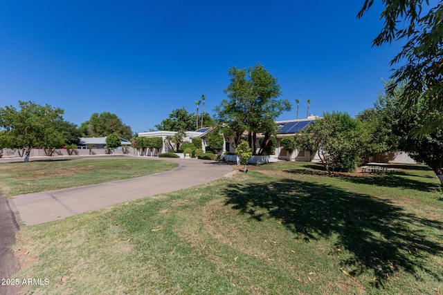 5237 N 106th Ave, Glendale, AZ 85307 - obstructed view of property featuring roof mounted solar panels and a front lawn
