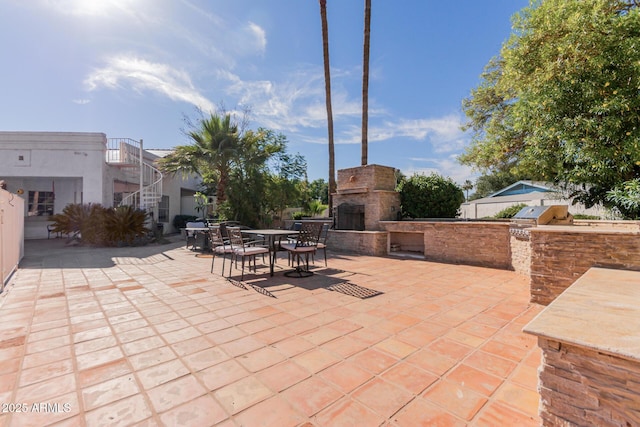 5237 N 106th Ave, Glendale, AZ 85307 - view of patio featuring an outdoor stone fireplace, area for grilling, and outdoor dining space