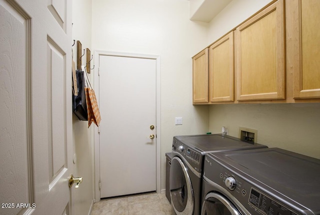 laundry room featuring light tile patterned flooring, cabinet space, and washer and dryer