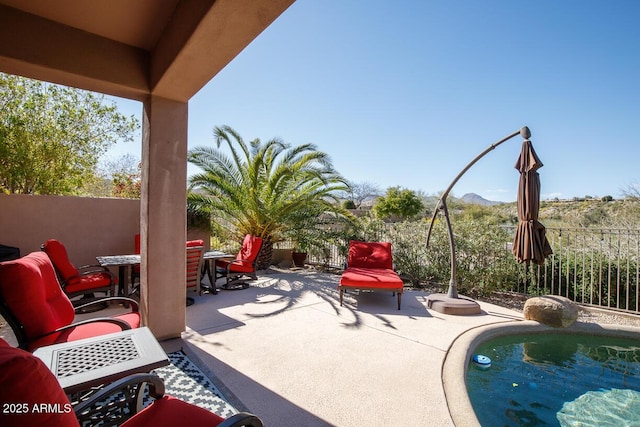 view of patio / terrace featuring a fenced in pool, outdoor dining space, and fence