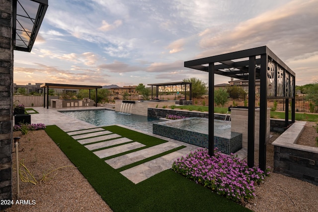 yard at dusk with a gazebo, pool water feature, and a patio area