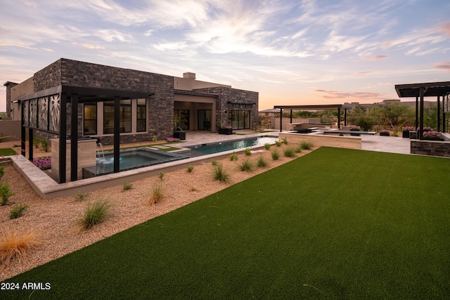 exterior space featuring a swimming pool with hot tub and a patio area