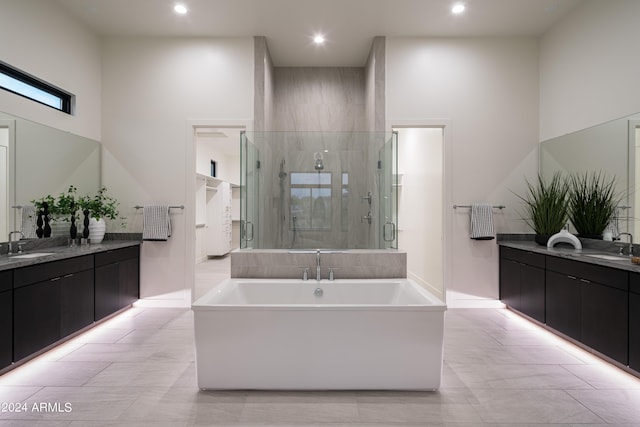 bathroom featuring vanity, a towering ceiling, and plus walk in shower