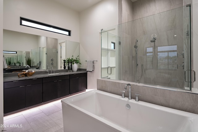 bathroom with vanity and shower with separate bathtub