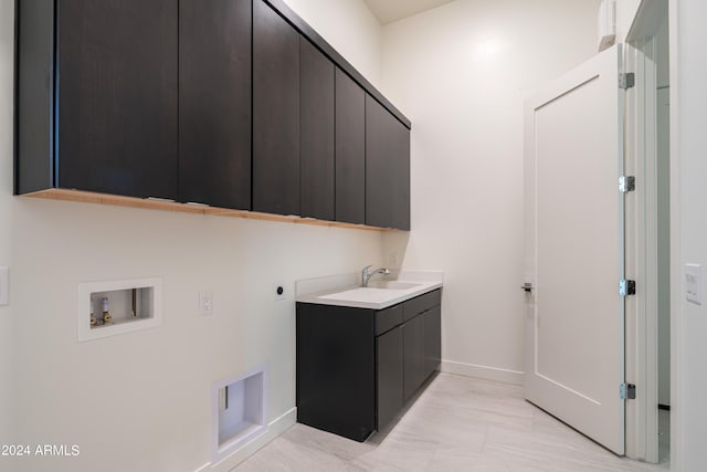 laundry area with sink, hookup for a washing machine, cabinets, and hookup for an electric dryer