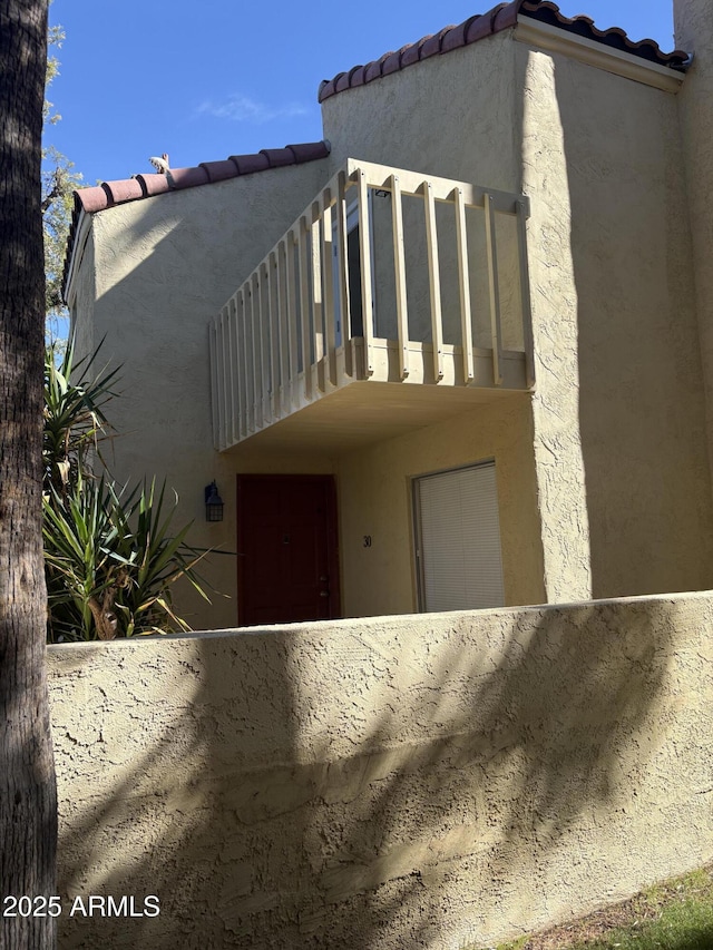 view of side of property with a balcony