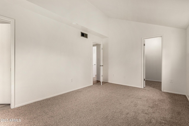 unfurnished room with carpet flooring, lofted ceiling, and baseboards