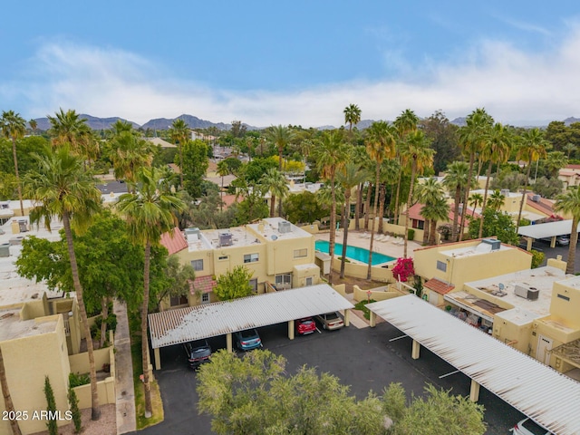 drone / aerial view of a pool and a mountainous background