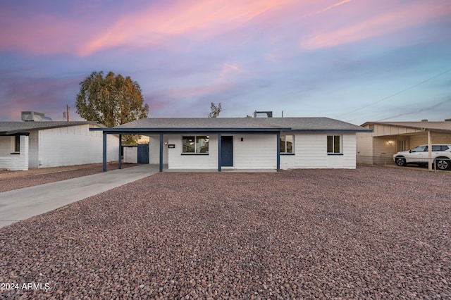 single story home featuring a porch and a carport