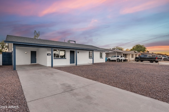 ranch-style home featuring a carport