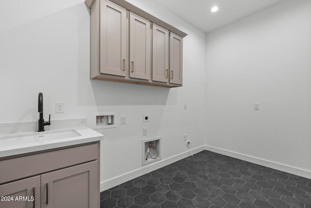 laundry room featuring washer hookup, sink, gas dryer hookup, cabinets, and electric dryer hookup