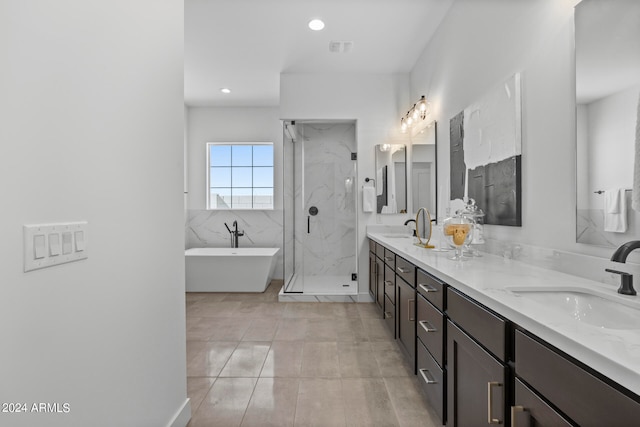 bathroom with tile patterned floors, separate shower and tub, and vanity