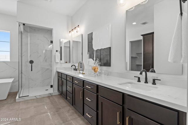 bathroom featuring vanity, a shower with shower door, and tile patterned floors