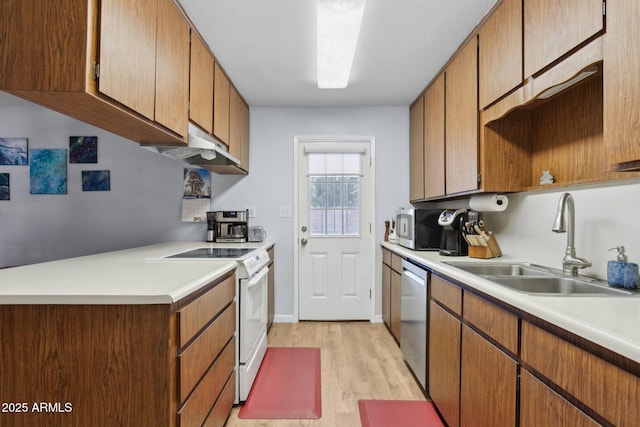 kitchen with stainless steel appliances, sink, and light wood-type flooring