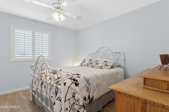 bedroom with hardwood / wood-style floors and ceiling fan