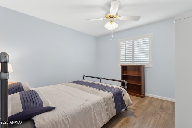 bedroom featuring hardwood / wood-style flooring and ceiling fan