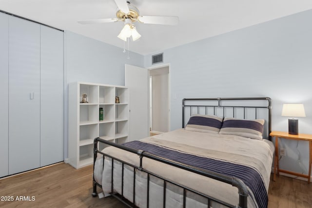 bedroom with ceiling fan and hardwood / wood-style floors