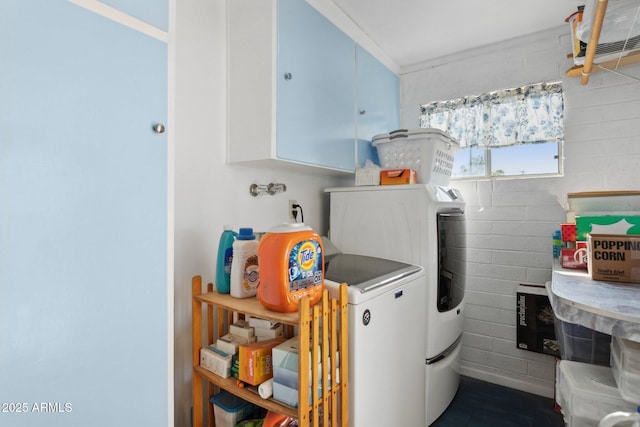 laundry room with cabinets and washer and clothes dryer