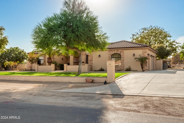 mediterranean / spanish home featuring a garage