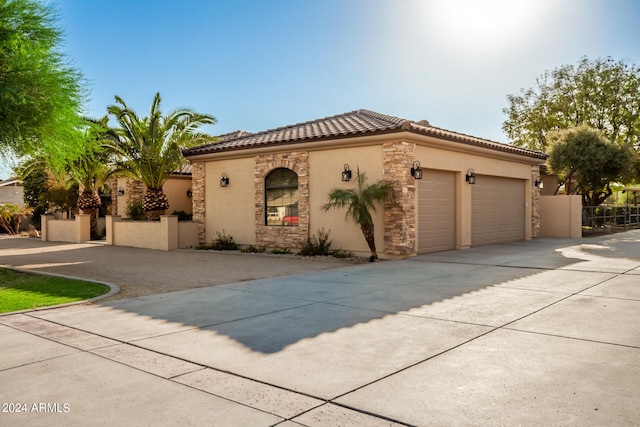 mediterranean / spanish-style house with a garage