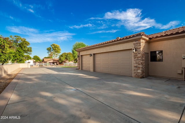 view of side of home featuring a garage