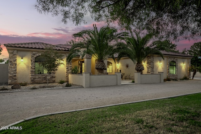 mediterranean / spanish house featuring a lawn