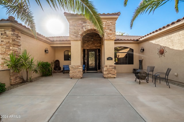 entrance to property featuring a patio