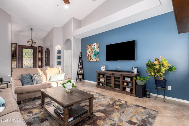 tiled living room with vaulted ceiling and ceiling fan