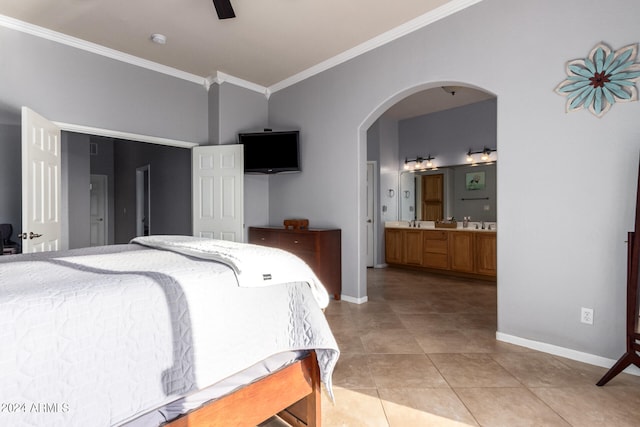 tiled bedroom with sink, ornamental molding, ensuite bathroom, and ceiling fan