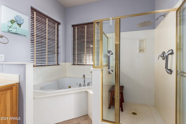 bathroom featuring vanity, plus walk in shower, and tile patterned floors