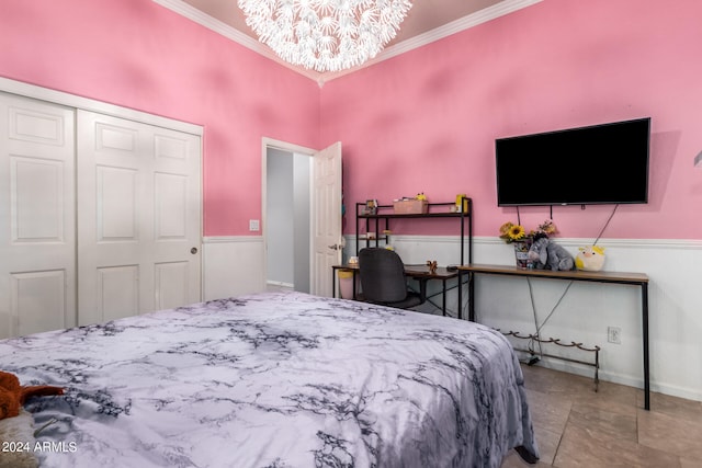 bedroom featuring a towering ceiling, a closet, crown molding, and a chandelier