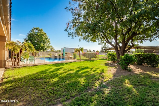 view of yard featuring a fenced in pool