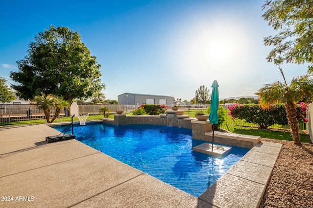 view of pool with a patio area and pool water feature