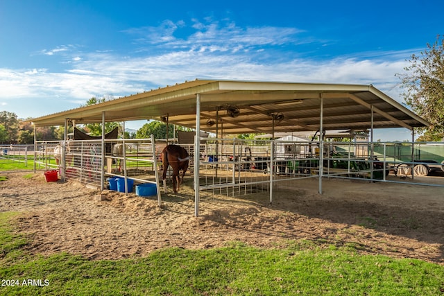 view of stable with a rural view