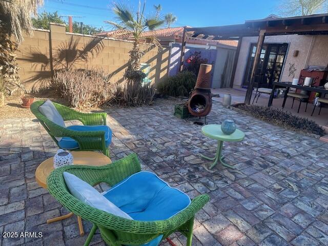 view of patio featuring fence private yard and a fire pit