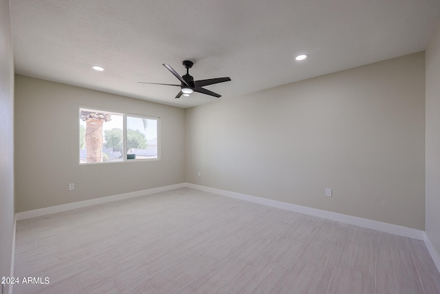 unfurnished room featuring ceiling fan, a textured ceiling, and light hardwood / wood-style flooring