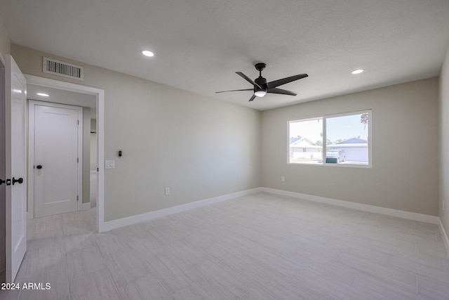 spare room featuring a textured ceiling and ceiling fan