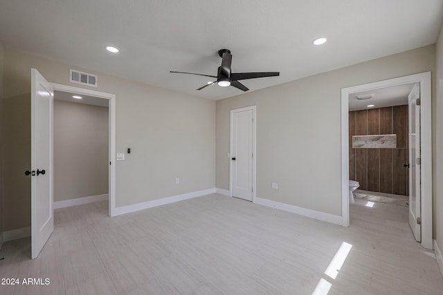 unfurnished bedroom with light hardwood / wood-style floors, ensuite bathroom, a closet, and ceiling fan