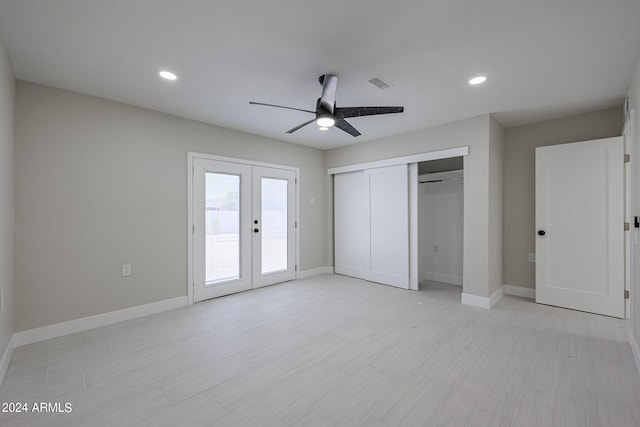 unfurnished bedroom featuring french doors, light hardwood / wood-style flooring, a closet, and ceiling fan