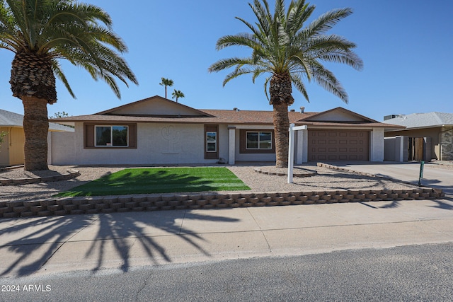 view of front facade with a front lawn and a garage