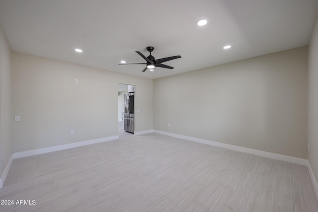 spare room featuring light hardwood / wood-style flooring and ceiling fan