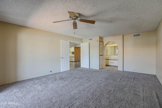 10410 N Cave Creek Rd Unit 2220, Phoenix, AZ 85020 - unfurnished bedroom with arched walkways, carpet floors, a textured ceiling, and ceiling fan