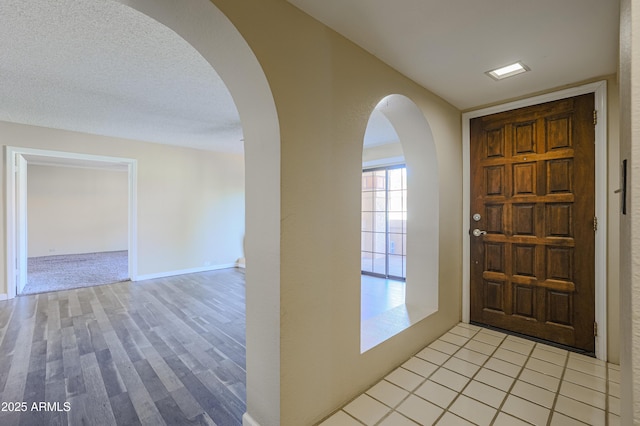 10410 N Cave Creek Rd Unit 2220, Phoenix, AZ 85020 - entryway with arched walkways and light wood finished floors