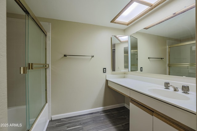 10410 N Cave Creek Rd Unit 2220, Phoenix, AZ 85020 - bathroom with wood finished floors, vanity, baseboards, and combined bath / shower with glass door