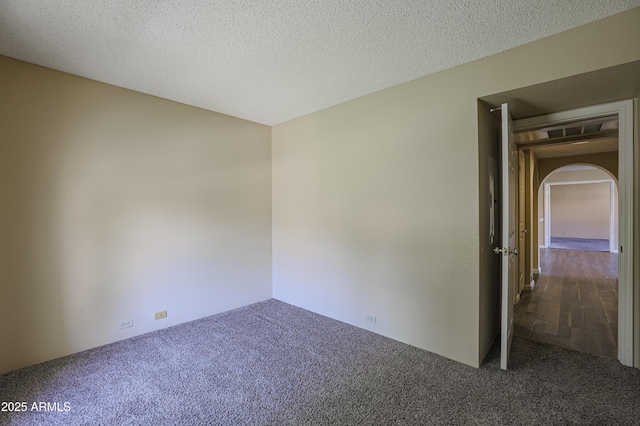 10410 N Cave Creek Rd Unit 2220, Phoenix, AZ 85020 - carpeted empty room featuring arched walkways and a textured ceiling