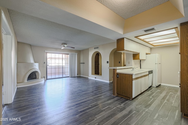 10410 N Cave Creek Rd Unit 2220, Phoenix, AZ 85020 - kitchen with a textured ceiling, dark wood finished floors, a fireplace, light countertops, and a ceiling fan