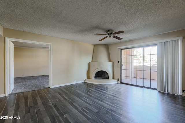10410 N Cave Creek Rd Unit 2220, Phoenix, AZ 85020 - unfurnished living room featuring ceiling fan, dark wood-style floors, a large fireplace, baseboards, and a textured ceiling