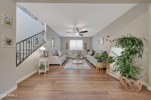 living room featuring ceiling fan and light hardwood / wood-style floors